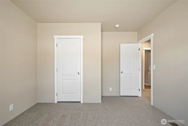 an empty room with closet area
