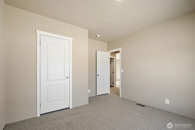 an empty room with closet area