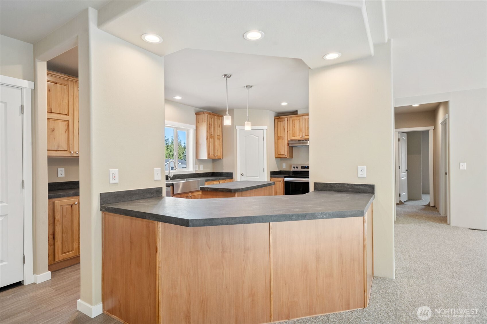 73 Butterfly Lane Sequim, WA 98382 - Photo 4 of 34 a kitchen with kitchen island a sink appliances and a counter top space