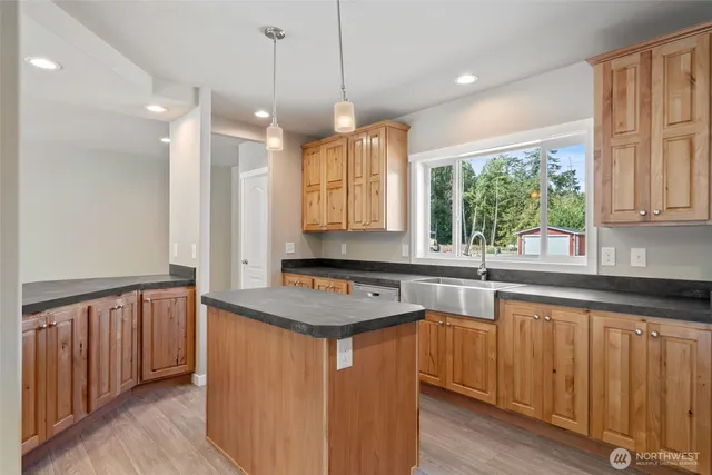 a kitchen that has a sink a window and appliances