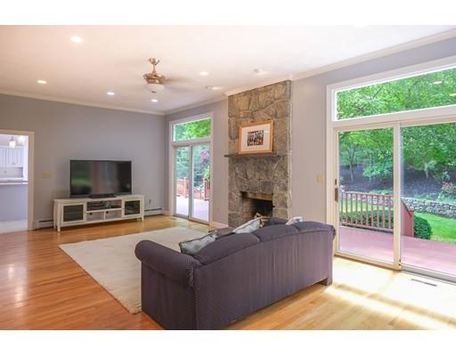 54 Bigelow Drive Sudbury, MA 01776 - Photo 11 of 40 a living room with furniture a flat screen tv and a fireplace