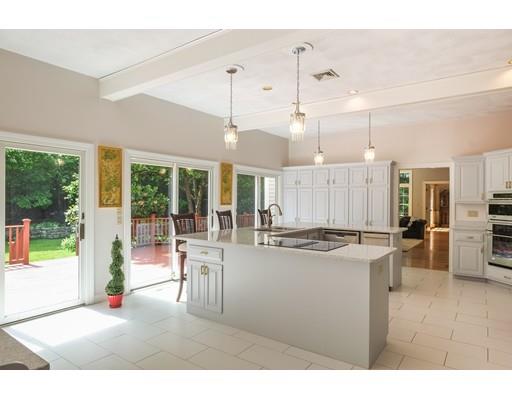 54 Bigelow Drive Sudbury, MA 01776 - Photo 18 of 40 a kitchen with stainless steel appliances granite countertop a stove and a refrigerator