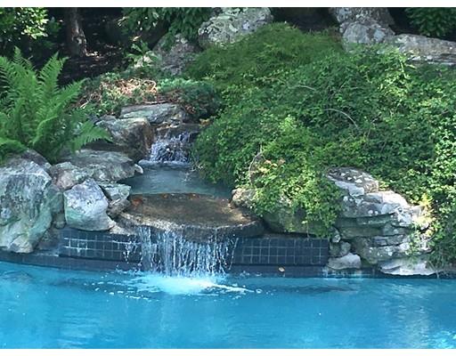 54 Bigelow Drive Sudbury, MA 01776 - Photo 26 of 40 a view of a yard with large trees and plants