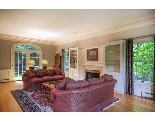 54 Bigelow Drive Sudbury, MA 01776 - Photo 5 of 40 a living room with furniture a fireplace and a large window