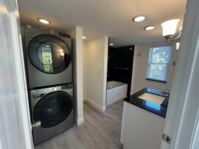 a view of a hallway with washer and dryer