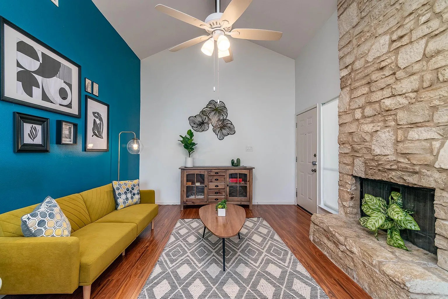 5405 Brompton Circle, Unit B Austin, TX 78745 - Photo 4 of 19 Living room featuring high vaulted ceiling, ceiling fan, wood finished floors, and a fireplace