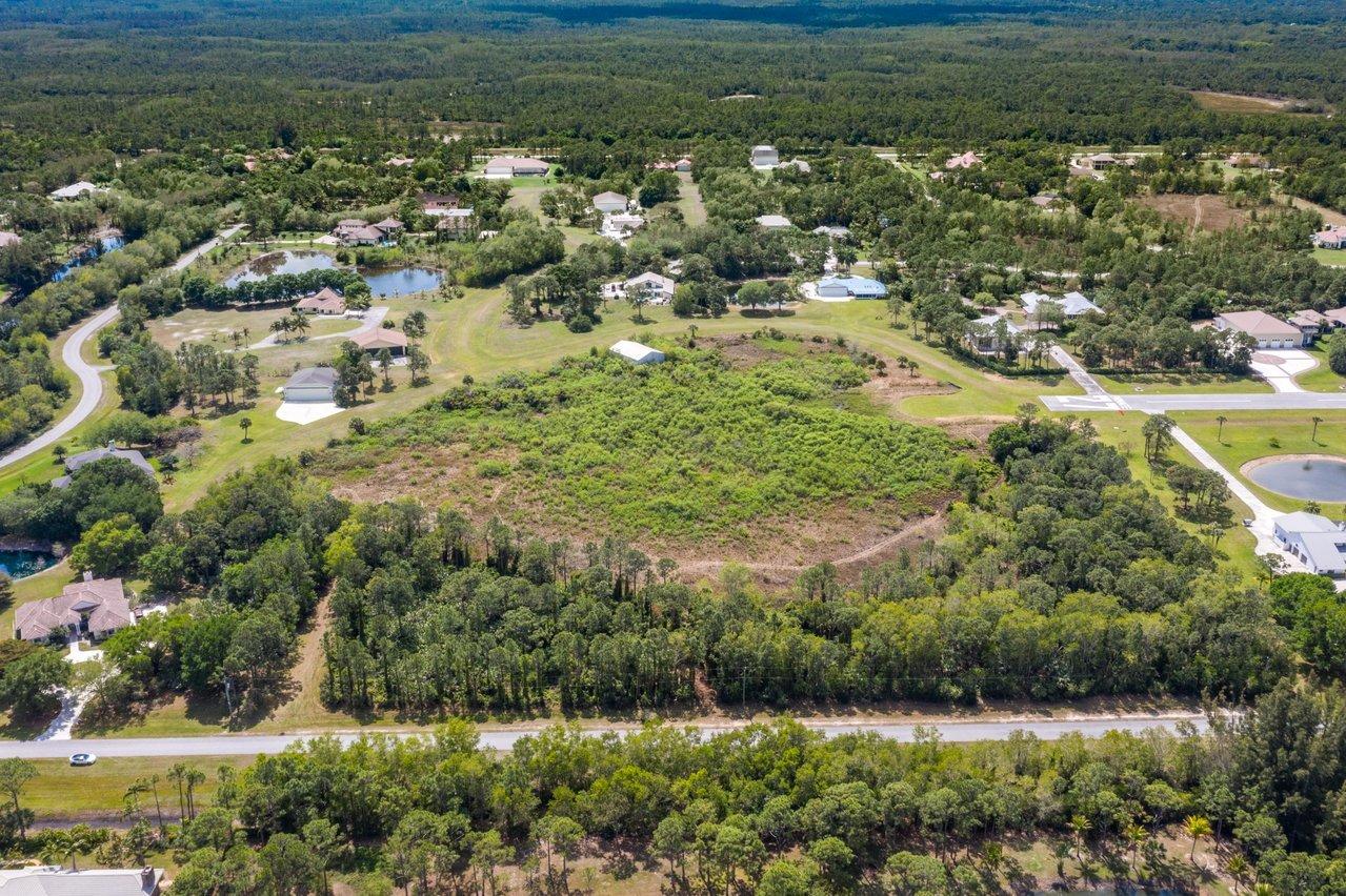 3200 Southeast Downwinds Road Jupiter, FL 33478 - Photo 1 of 28 an aerial view of residential houses with outdoor space and trees