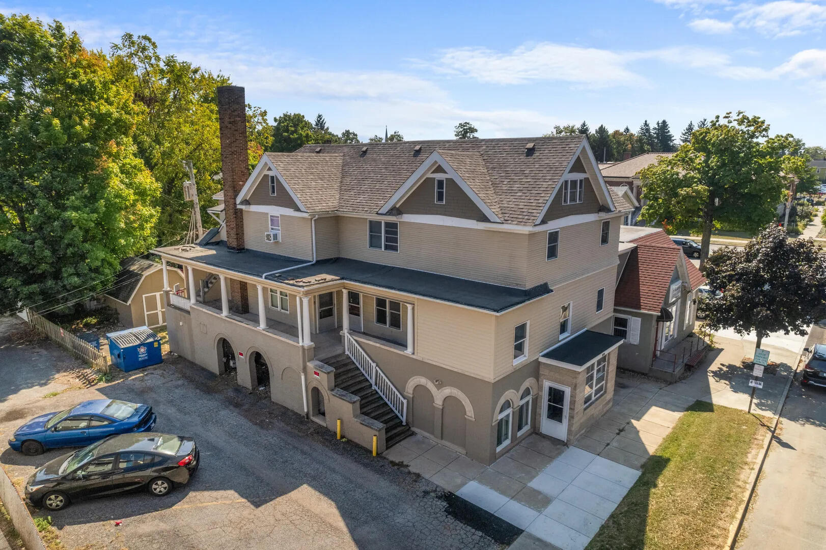 an aerial view of a house with swimming pool and furniture