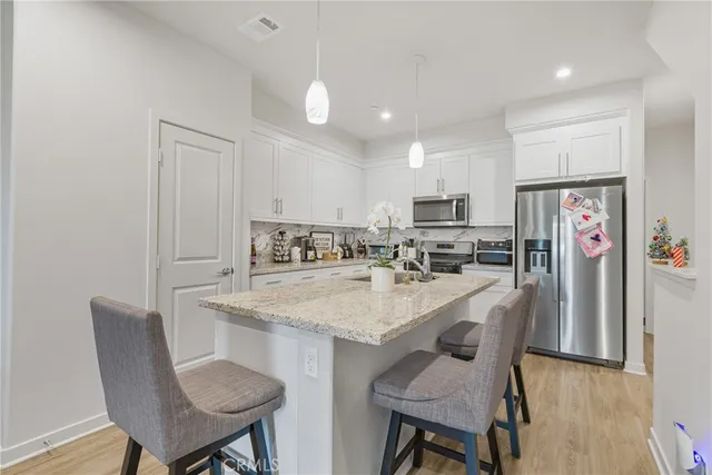 a view of kitchen with cabinets table and chairs