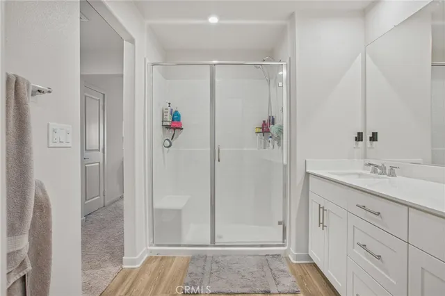 a bathroom with a shower sink and mirror