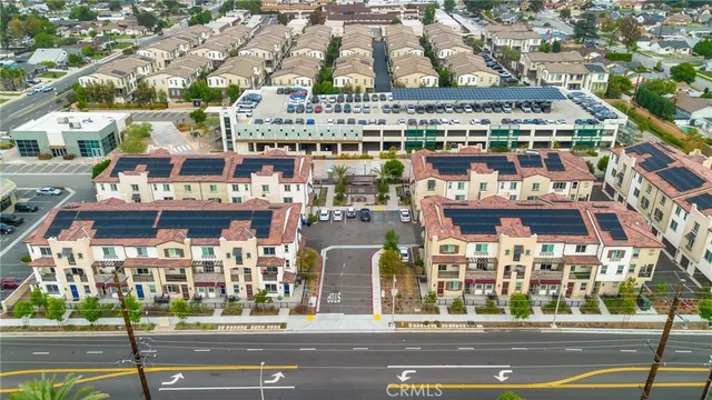a view of a building and a cars park side of the road