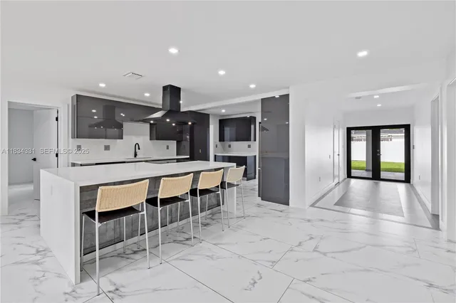a kitchen with stainless steel appliances granite countertop a refrigerator and a stove top oven