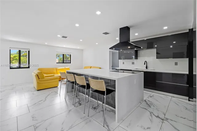 a open kitchen with white cabinets and stainless steel appliances