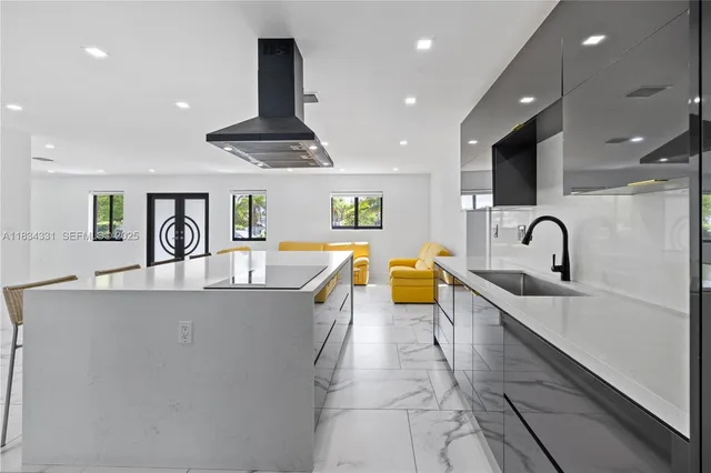 a living room with furniture and kitchen view