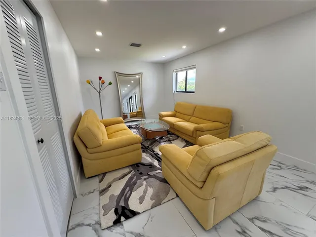 a bedroom with two beds and a desk