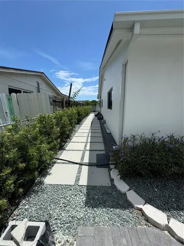 a view of an entrance with wooden floor and windows