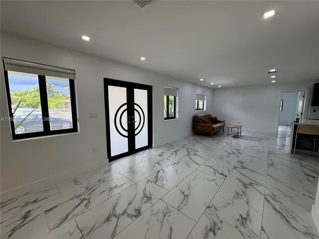 a kitchen with stainless steel appliances kitchen island granite countertop a sink and cabinets