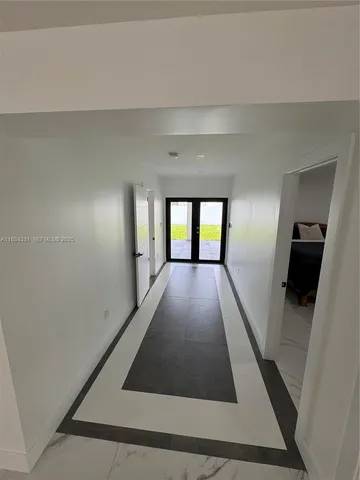 a large kitchen with kitchen island a sink stainless steel appliances and cabinets