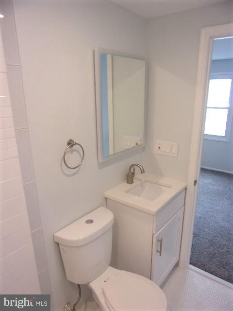 8012 Sheriff Road Landover, MD 20785 - Photo 22 of 24 a bathroom with a toilet a sink and mirror