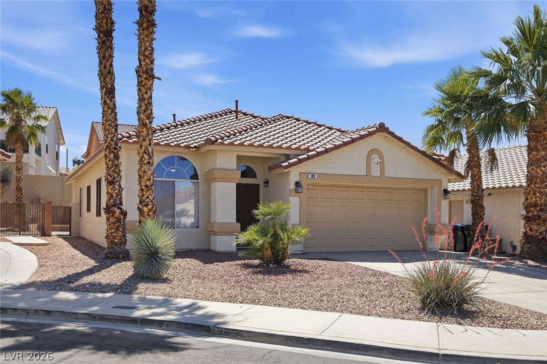 193 Oella Ridge Court Henderson, NV 89012 - Photo 30 of 32 A desert-friendly landscape surrounds this inviting residence with a charming stucco facade.