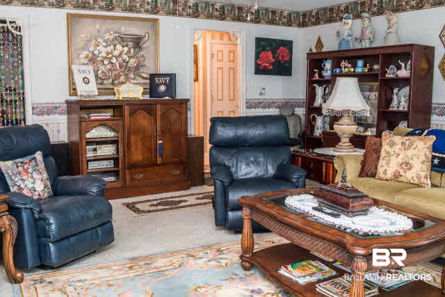1504 North Cedar Street Foley, AL 36535 - Photo 9 of 16 Large family room with a door to the covered carport.