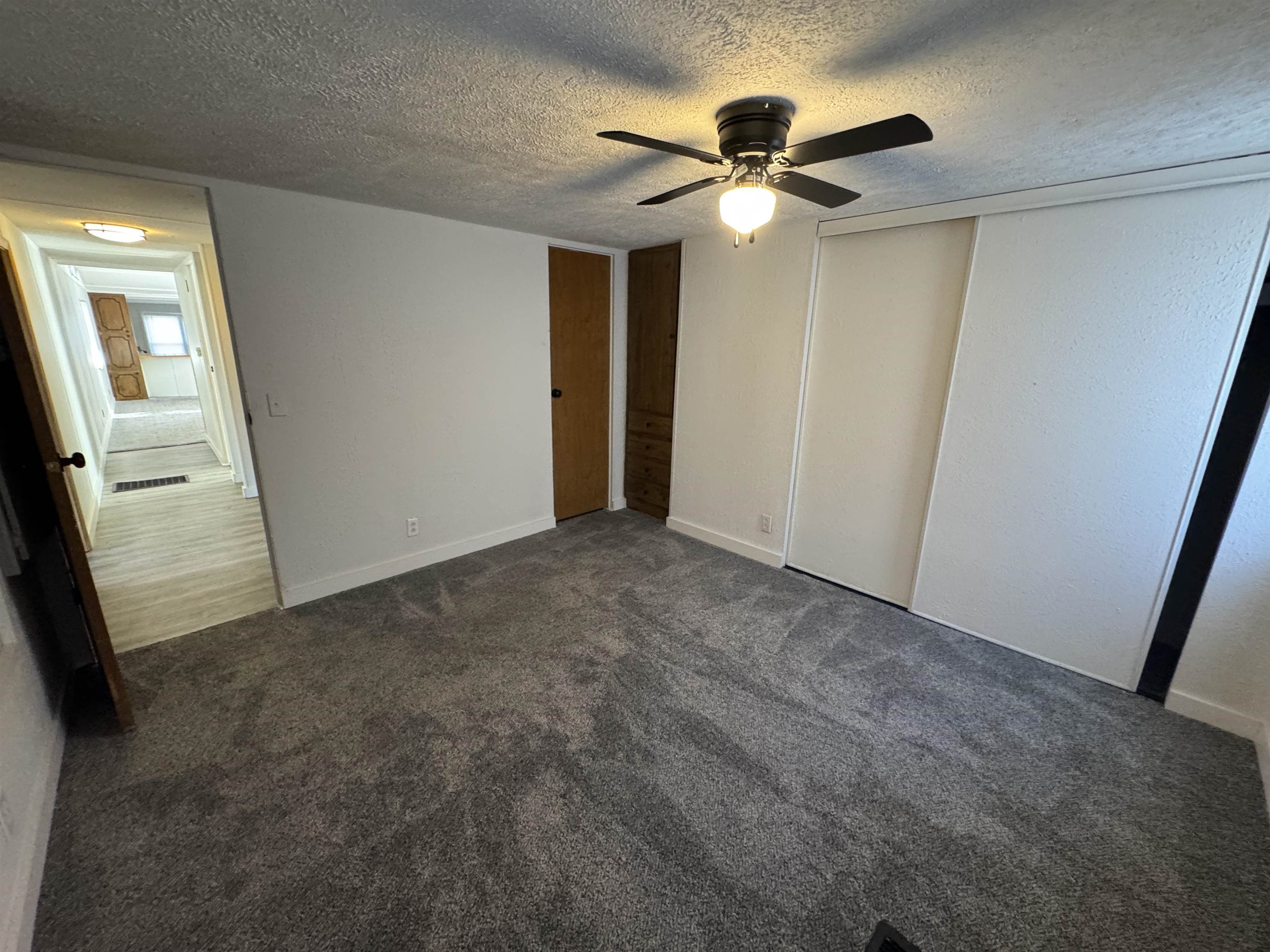 409 West 9th Street Sandoval, IL 62882 - Photo 19 of 31 a view of a hallway with a chandelier fan