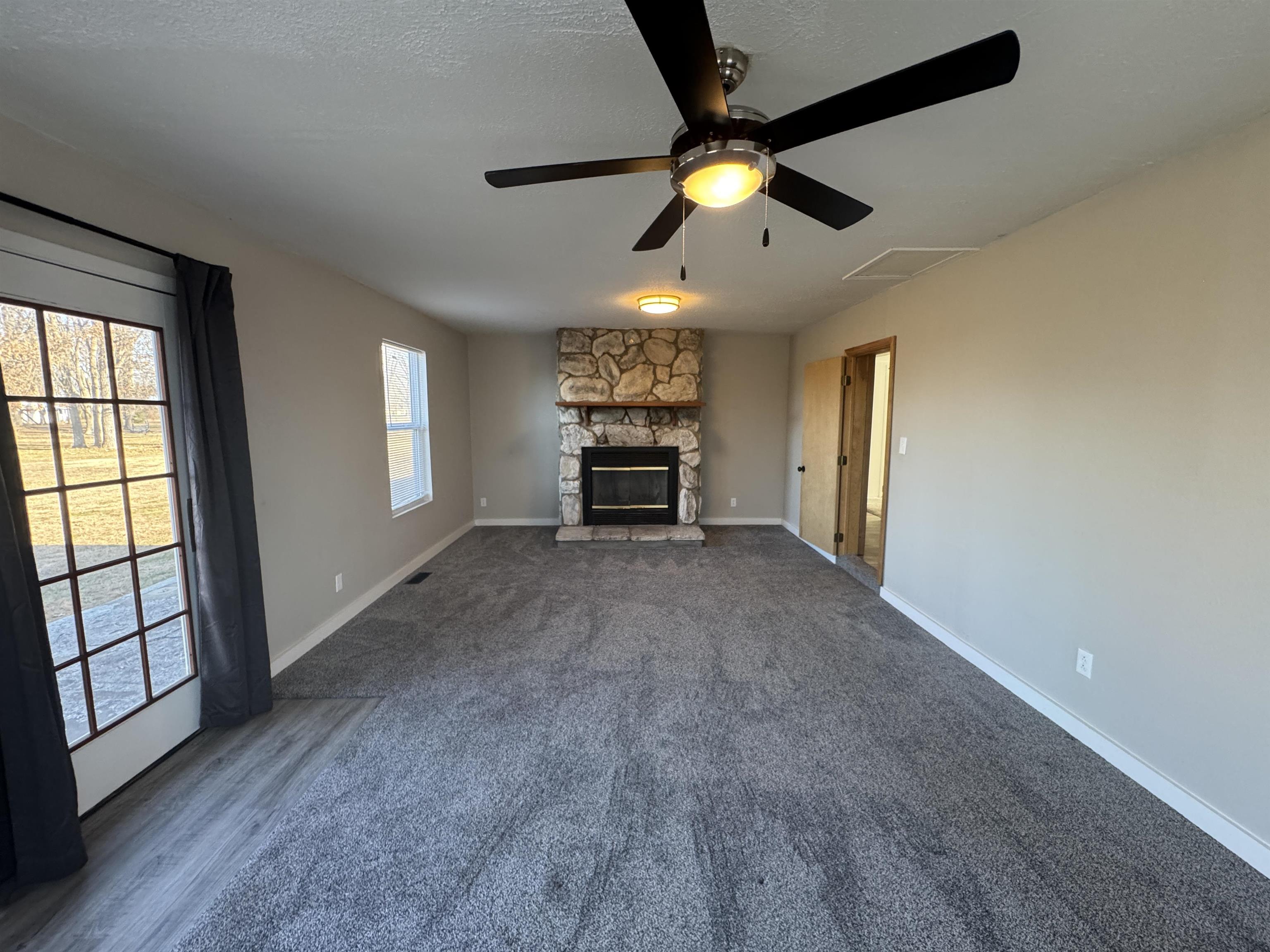 409 West 9th Street Sandoval, IL 62882 - Photo 23 of 31 an empty room with windows and ceiling fan