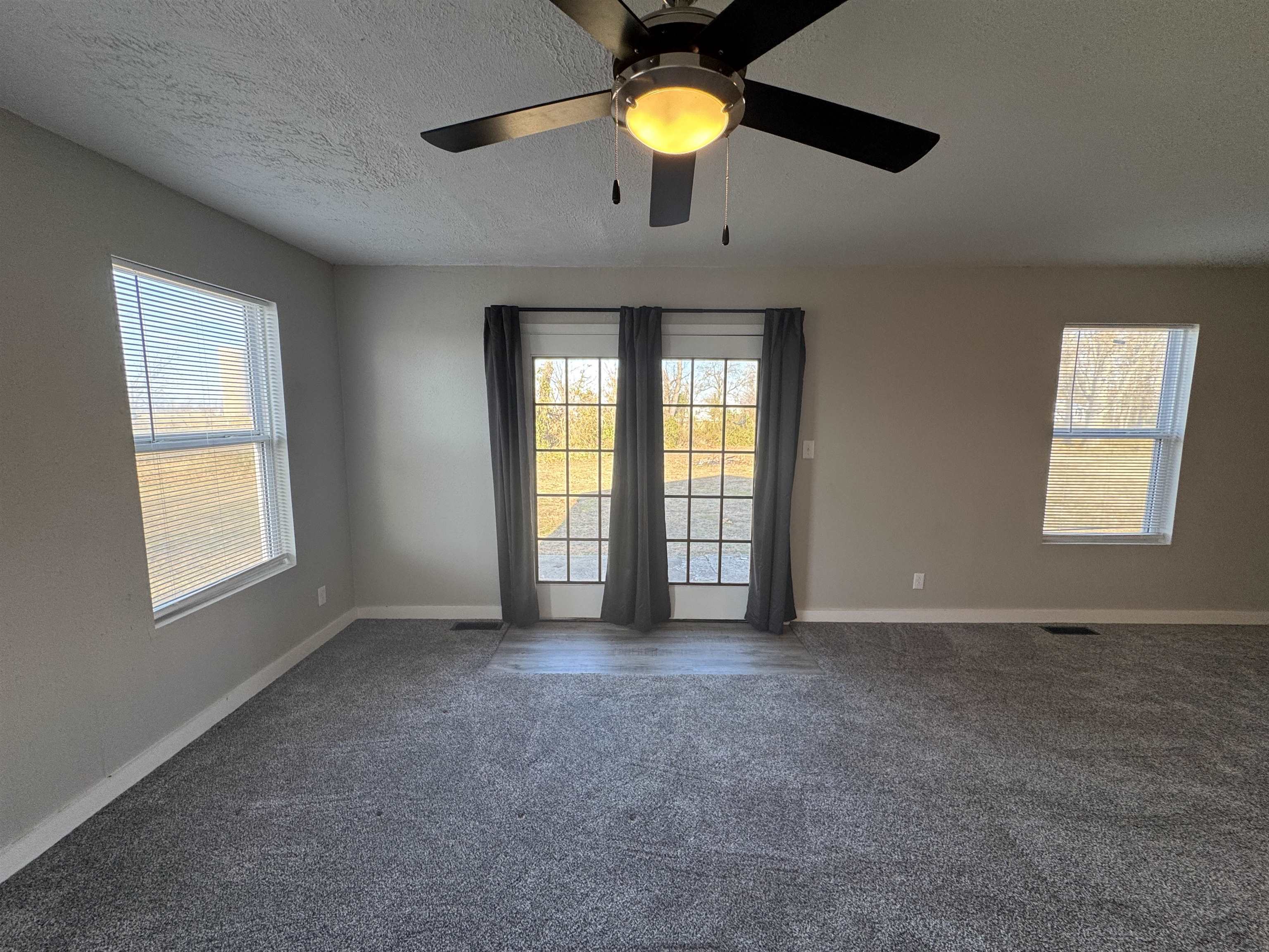 409 West 9th Street Sandoval, IL 62882 - Photo 24 of 31 an empty room with windows and chandelier fan