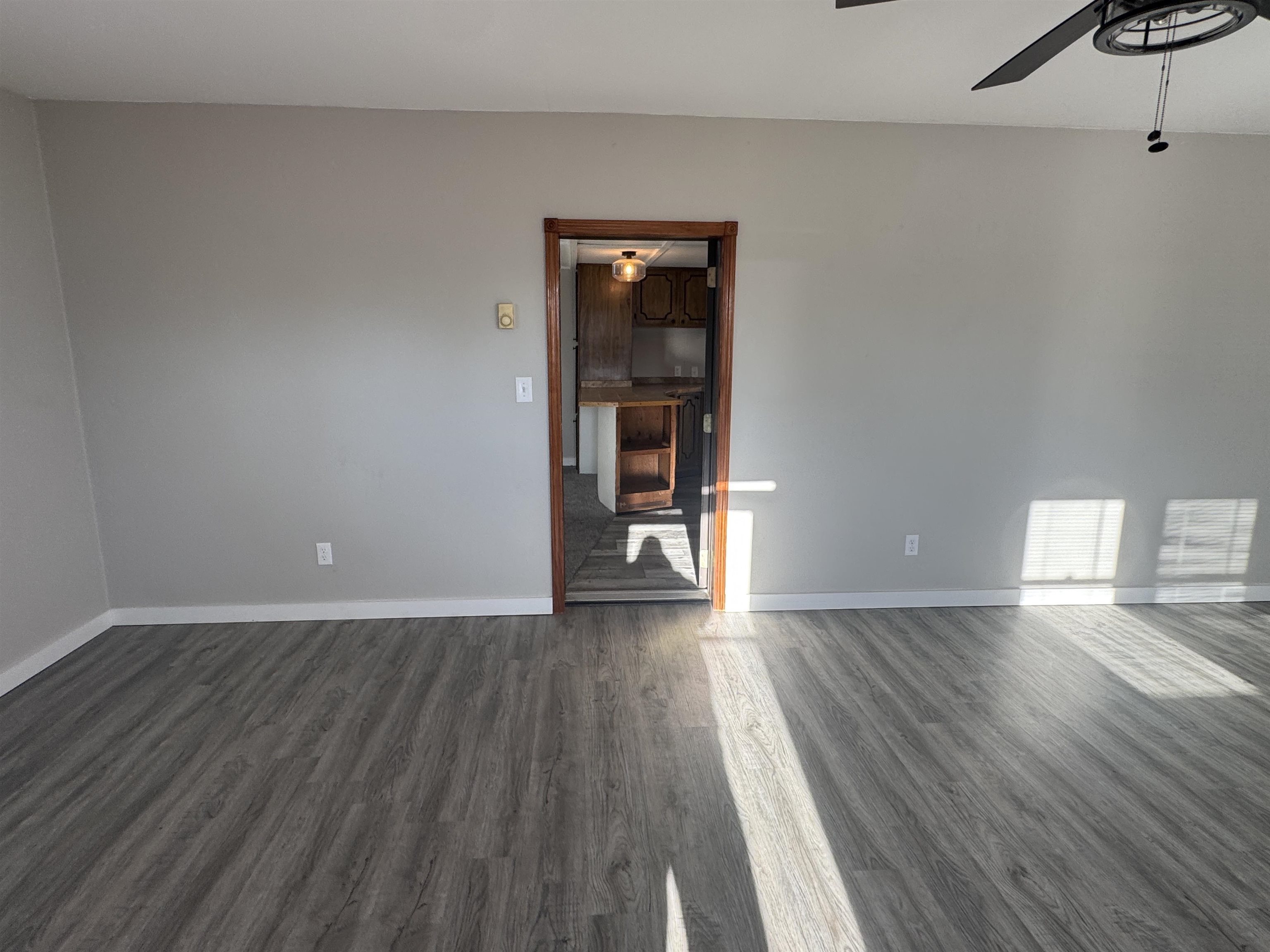 409 West 9th Street Sandoval, IL 62882 - Photo 3 of 31 a view of an empty room with wooden floor and a window
