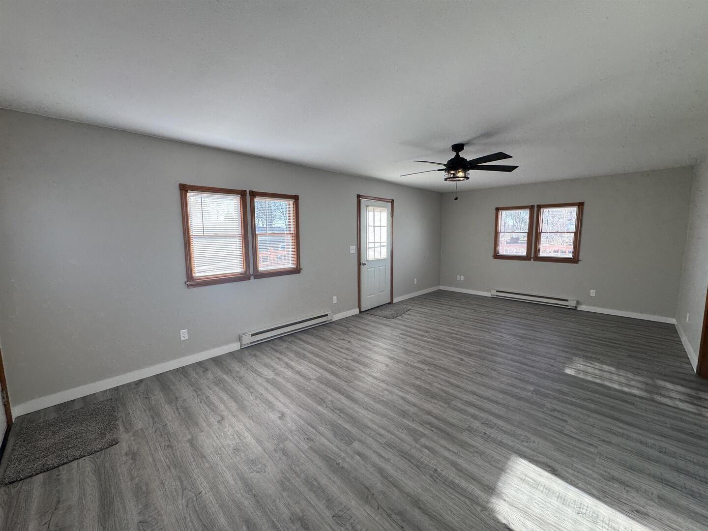 409 West 9th Street Sandoval, IL 62882 - Photo 4 of 31 wooden floor in an empty room with a window