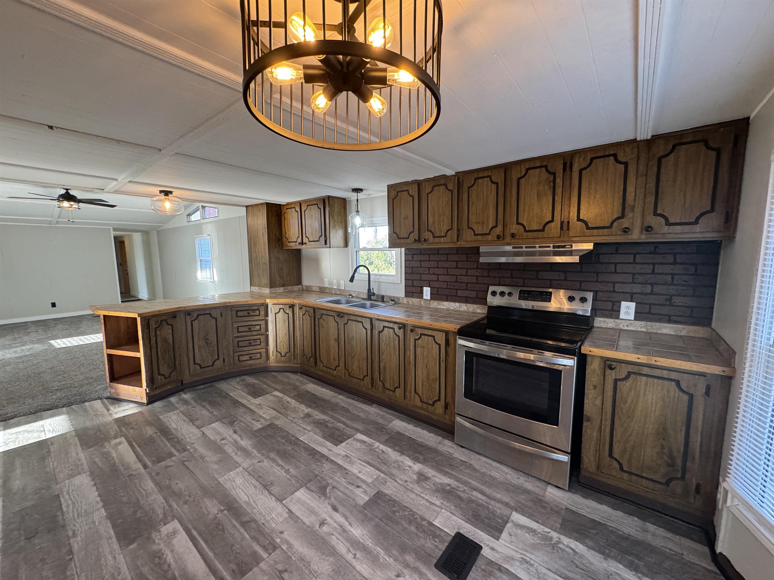 409 West 9th Street Sandoval, IL 62882 - Photo 8 of 31 a kitchen with stainless steel appliances granite countertop a stove a sink and a refrigerator