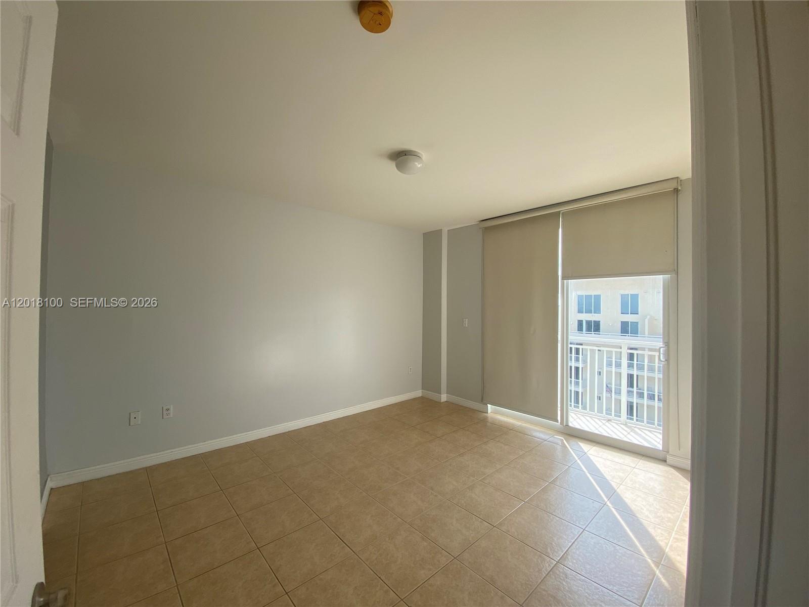 2425 Southwest 27th Avenue, Unit 1008 Miami, FL 33145 - Photo 2 of 20 a view of an empty room with a window