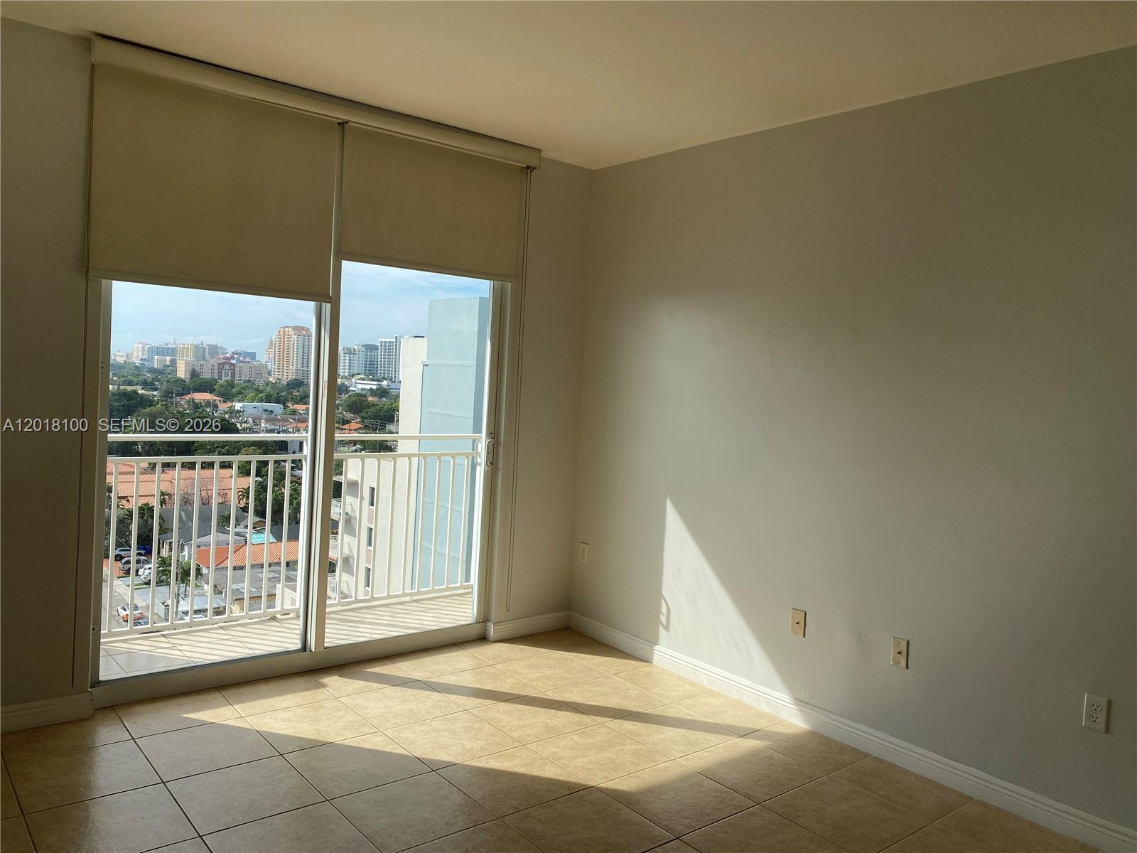2425 Southwest 27th Avenue, Unit 1008 Miami, FL 33145 - Photo 3 of 20 a view of an empty room with a window