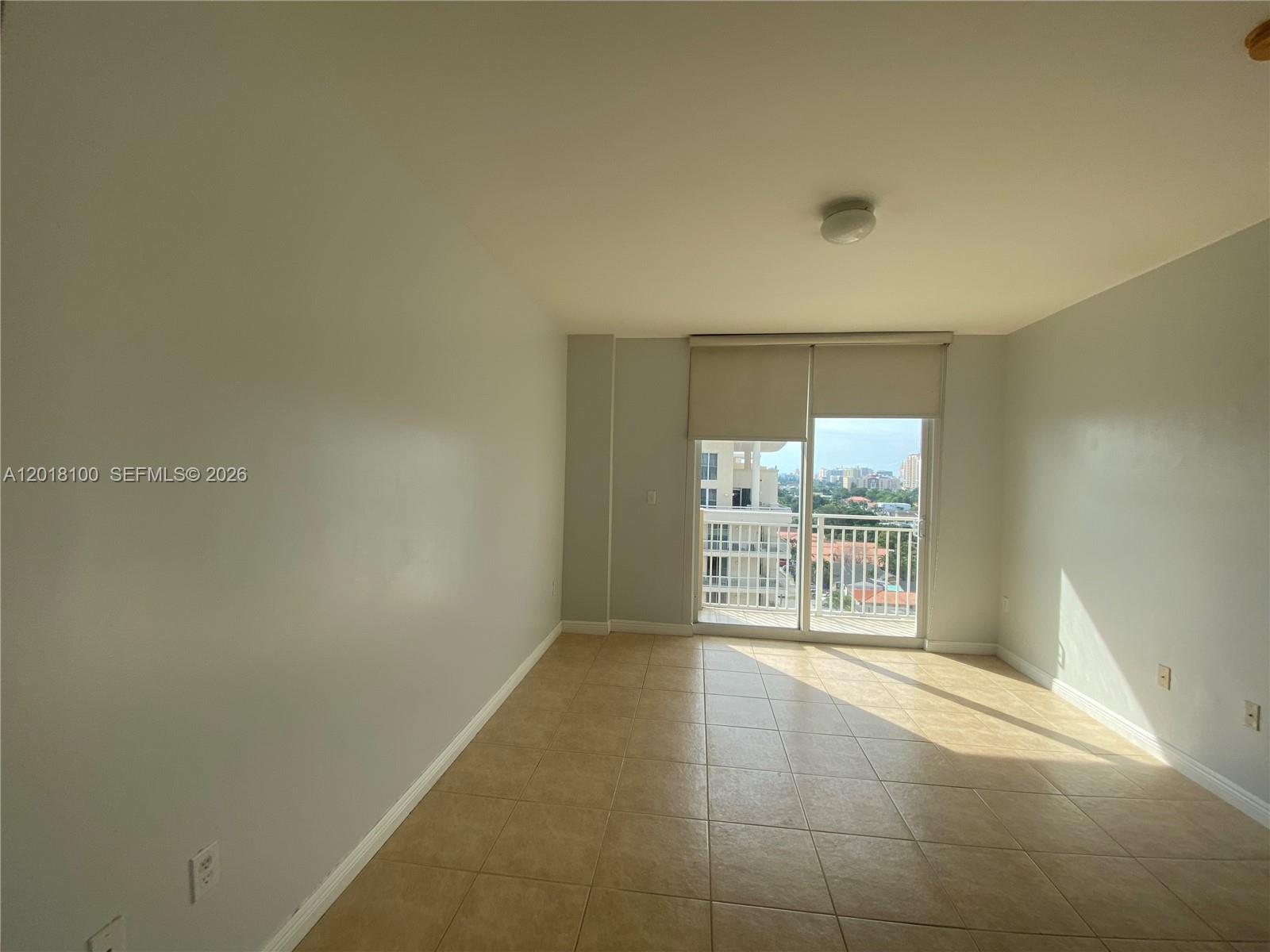 2425 Southwest 27th Avenue, Unit 1008 Miami, FL 33145 - Photo 5 of 20 a view of an empty room with a window