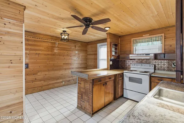 a kitchen with a stove cabinets and window