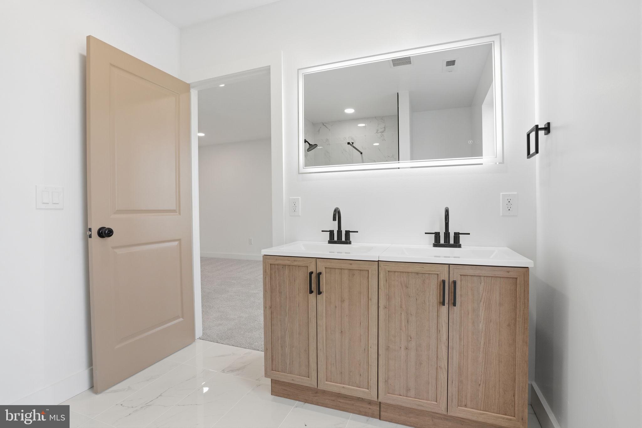 14 Inlet Road Levittown, PA 19057 - Photo 20 of 31 a bathroom with a sink a mirror and a vanity