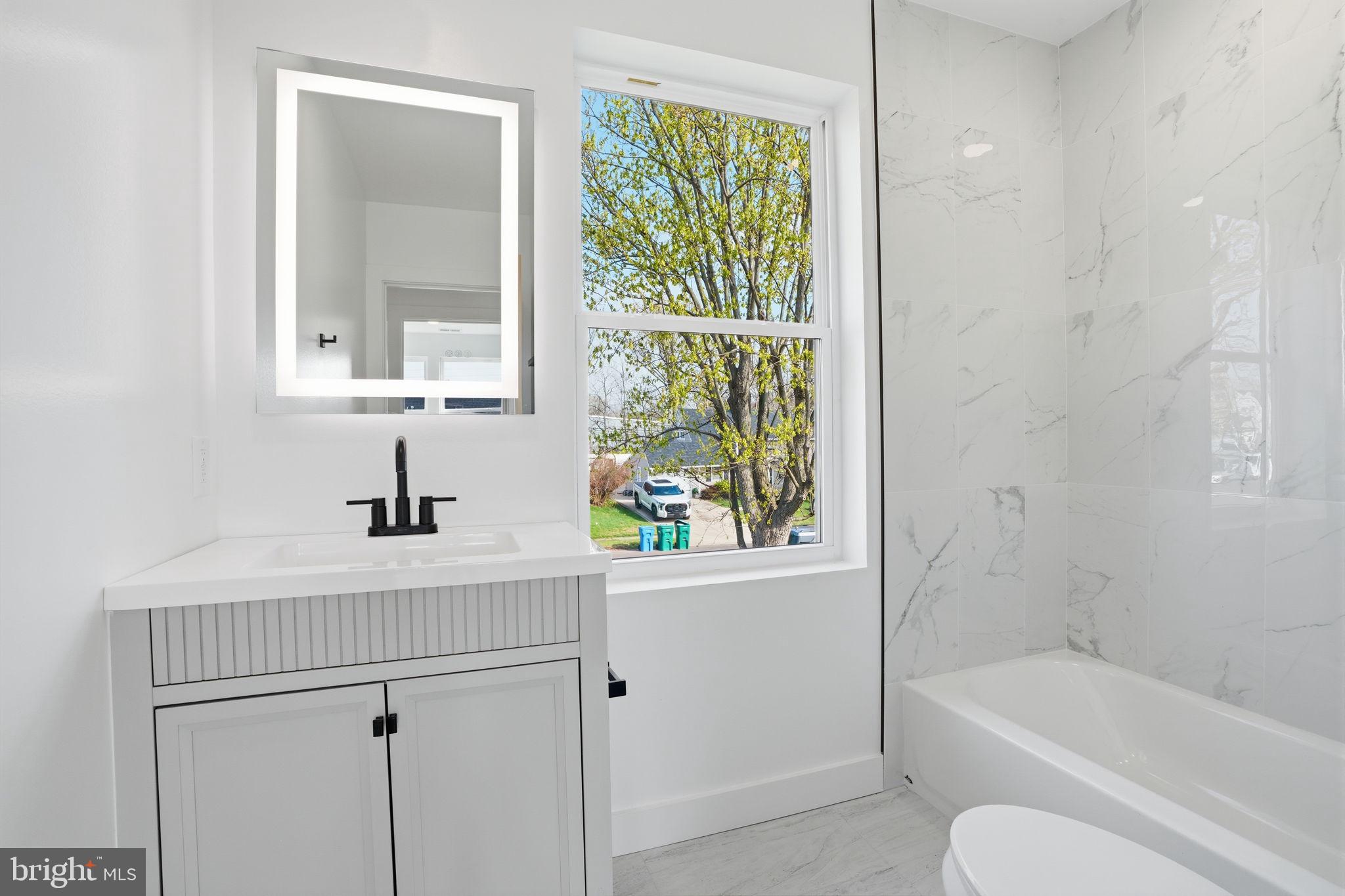14 Inlet Road Levittown, PA 19057 - Photo 23 of 31 a bathroom with a tub sink and mirror