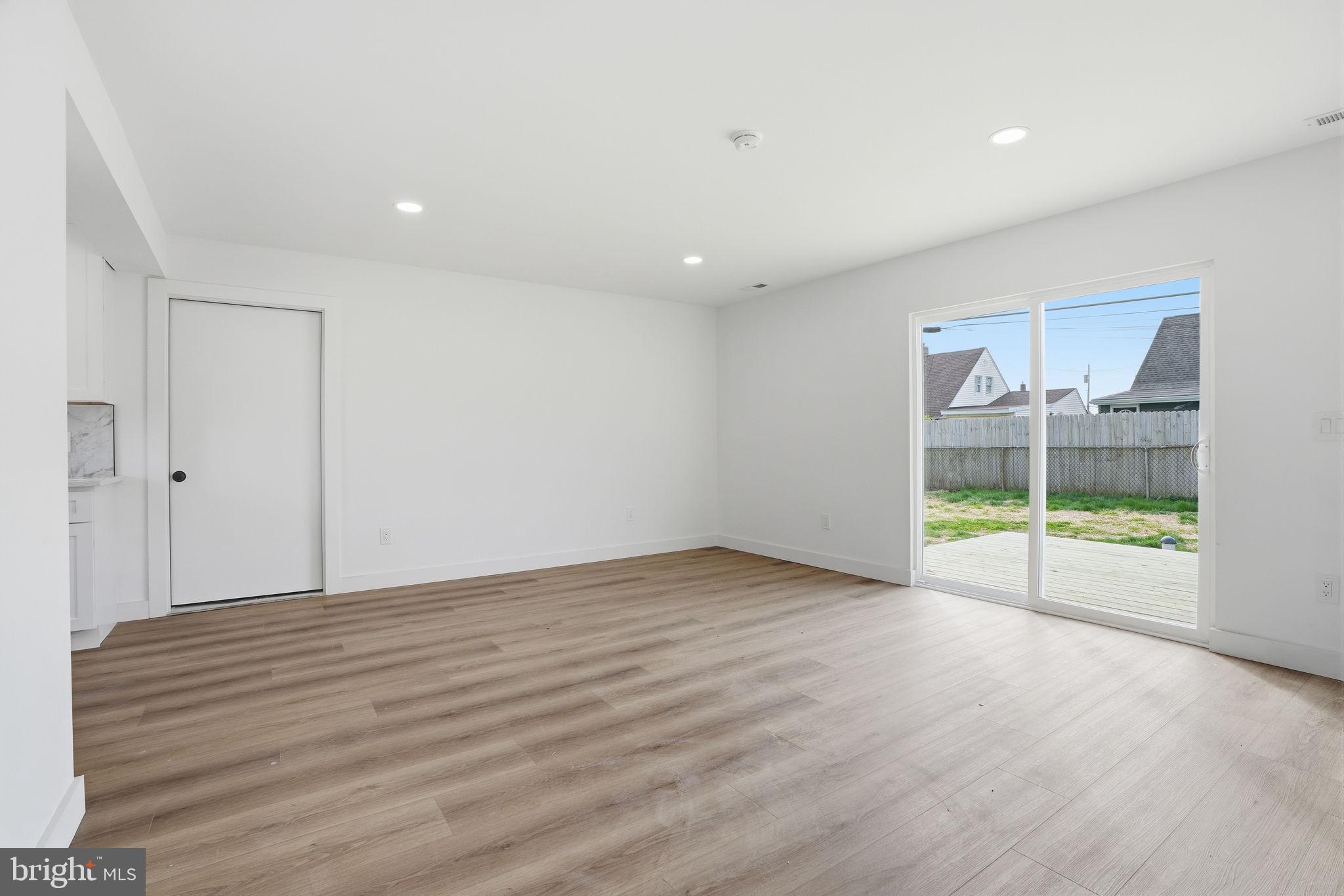 14 Inlet Road Levittown, PA 19057 - Photo 7 of 31 a view of an empty room with wooden floor and a window