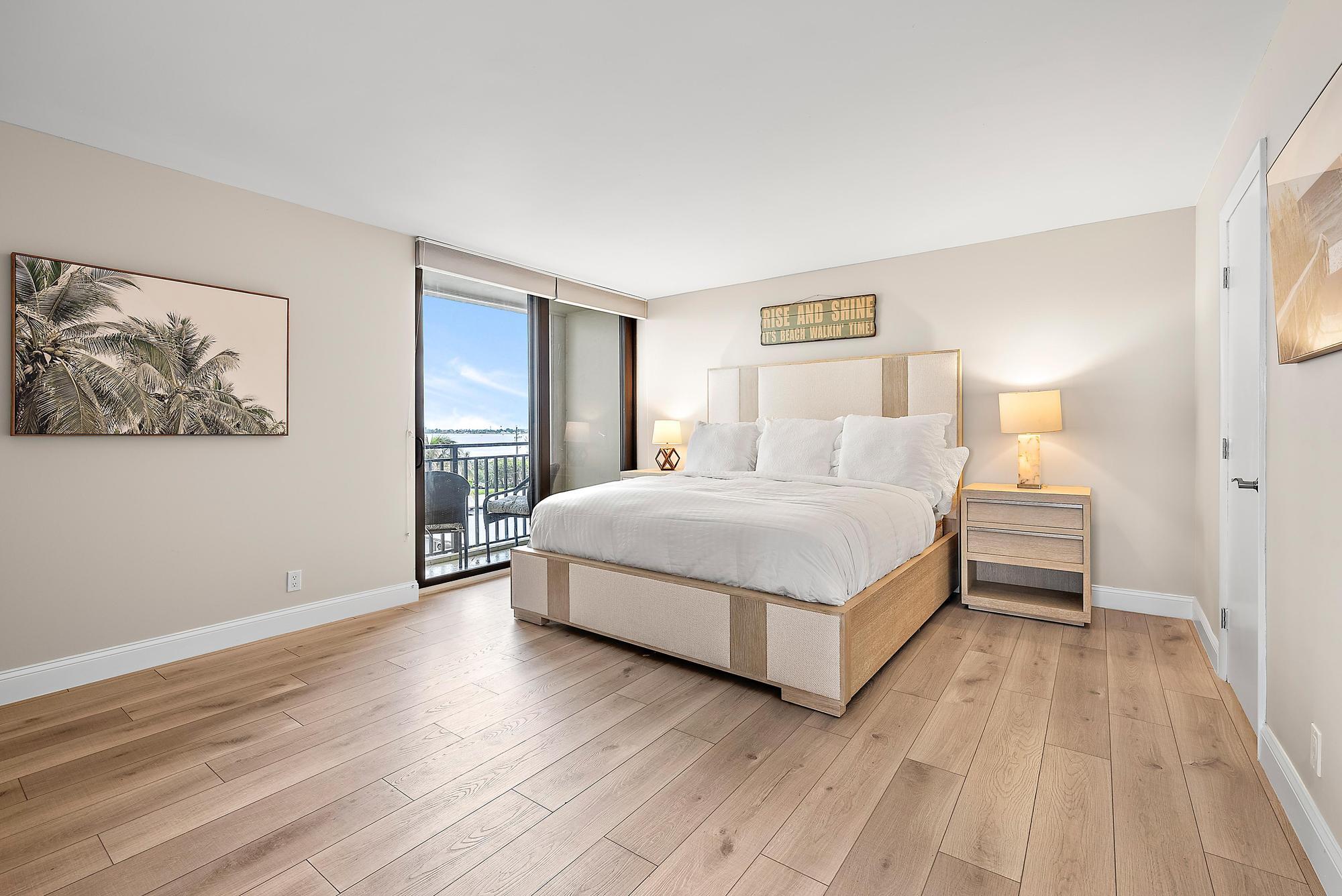 5460 North Ocean Drive, Unit 3B Riviera Beach, FL 33404 - Photo 13 of 26 a bedroom with a bed and a painting on the wall