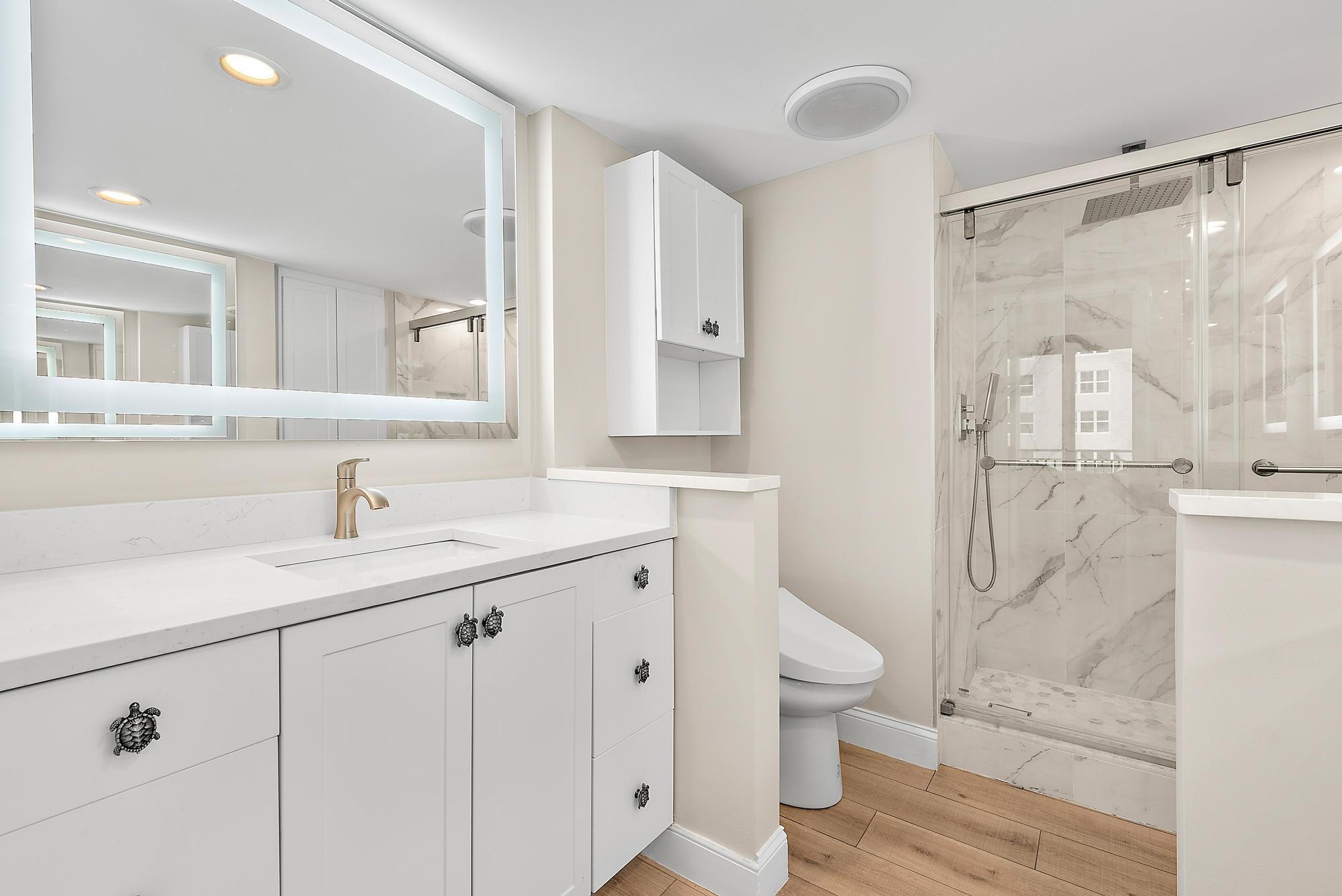 5460 North Ocean Drive, Unit 3B Riviera Beach, FL 33404 - Photo 15 of 26 a bathroom with a granite countertop sink a toilet and a shower