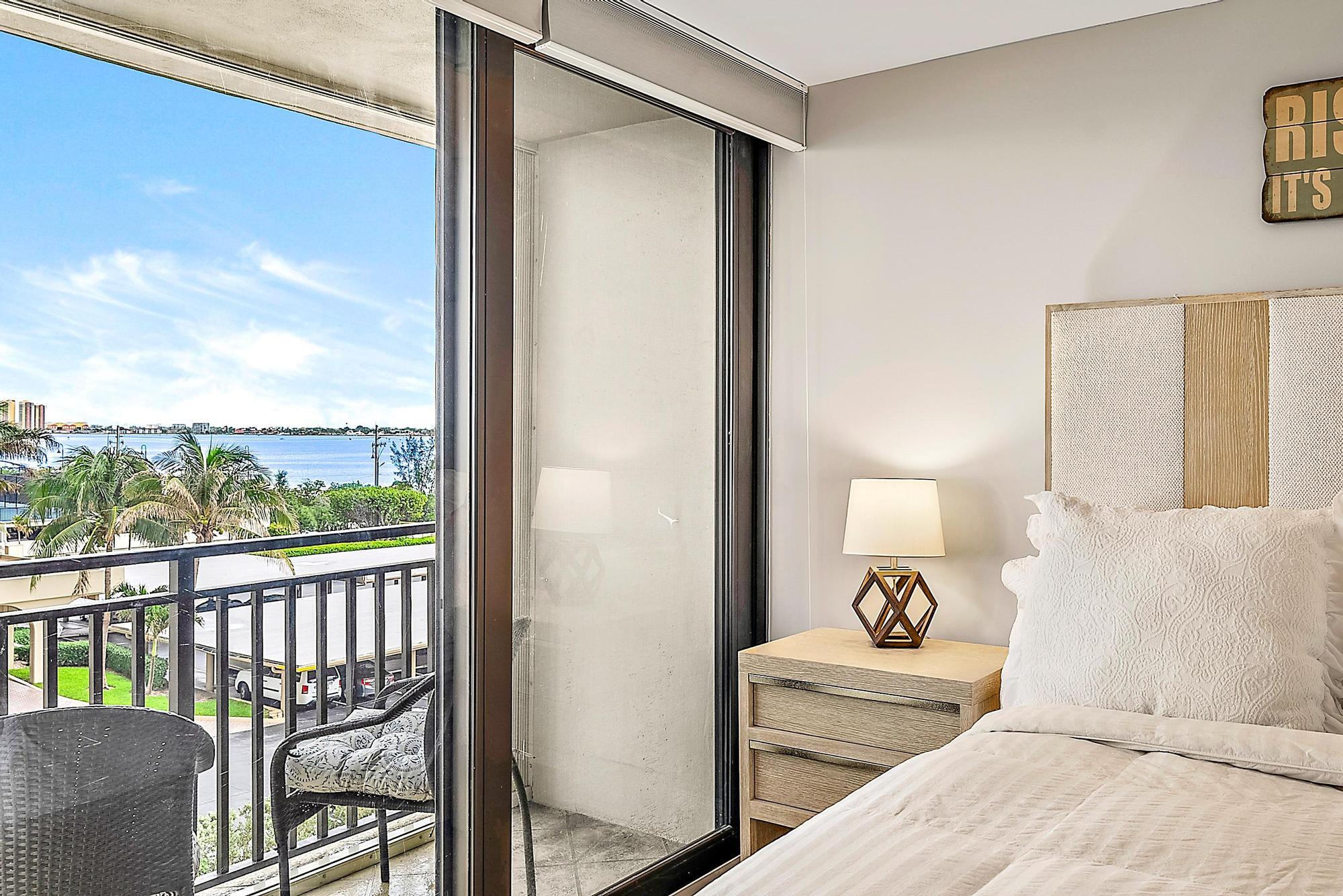 5460 North Ocean Drive, Unit 3B Riviera Beach, FL 33404 - Photo 17 of 26 a bedroom with a bed and glass window