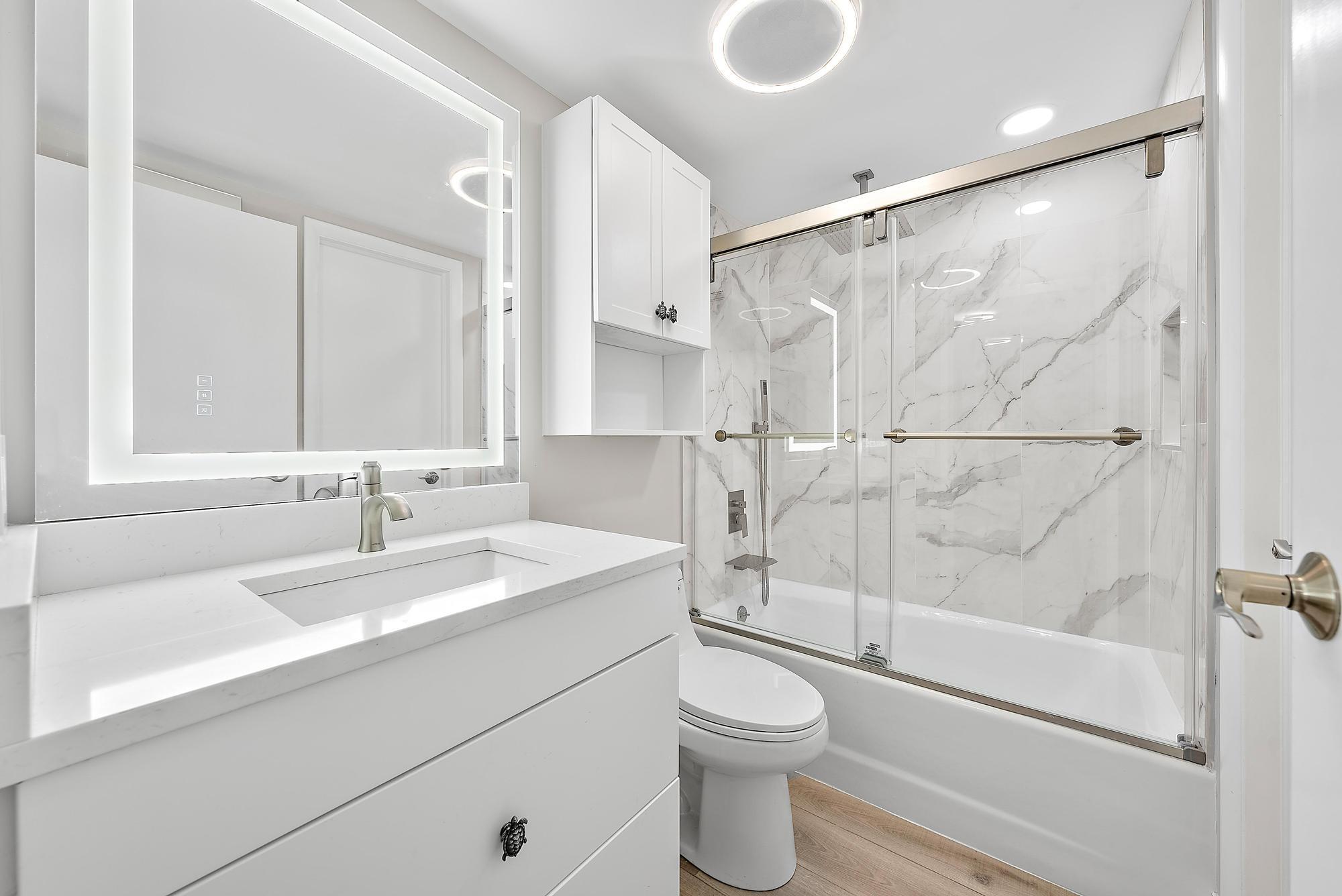 5460 North Ocean Drive, Unit 3B Riviera Beach, FL 33404 - Photo 20 of 26 a bathroom with a sink toilet and shower