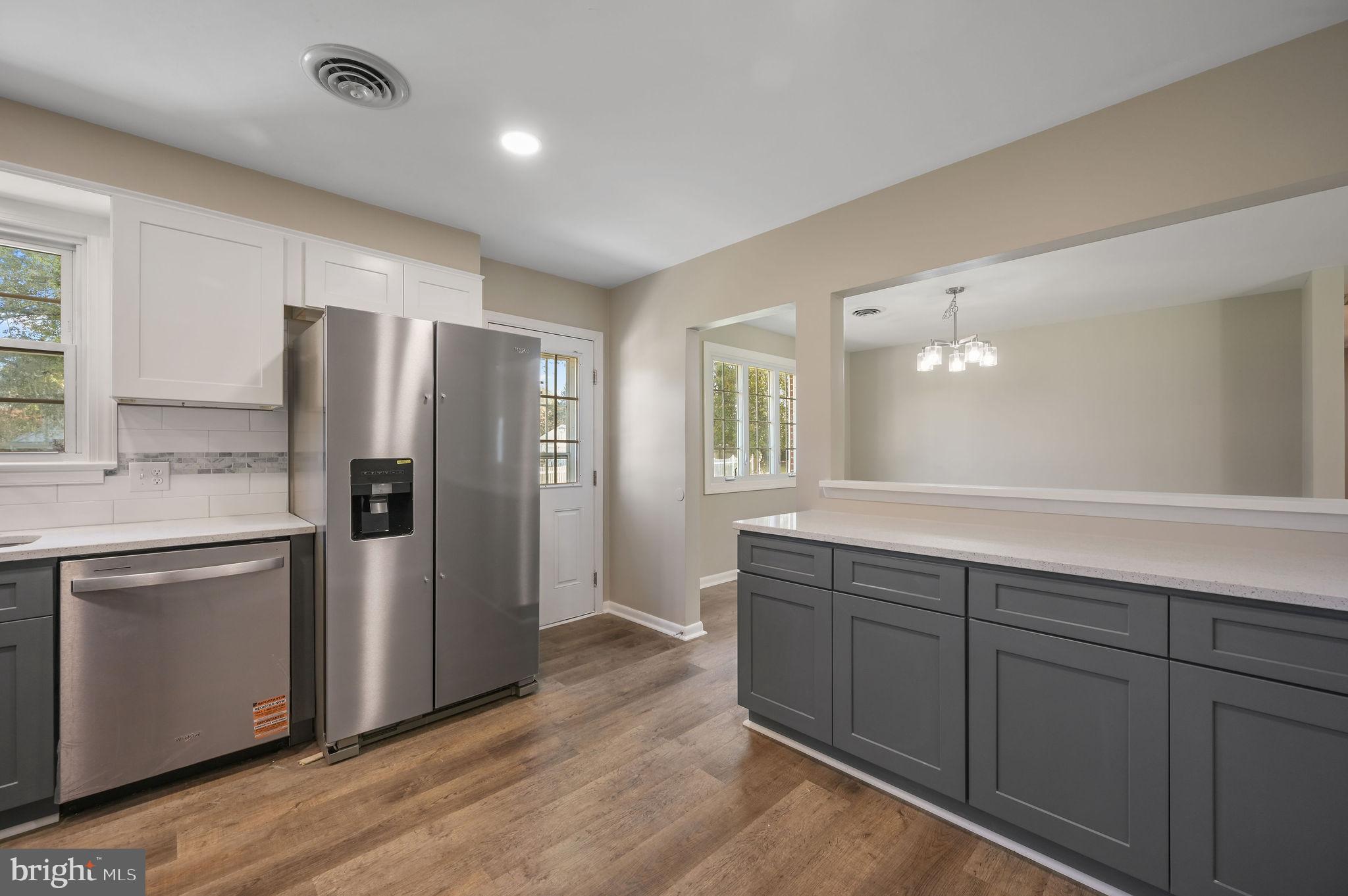 201 North Old Mill Road Dover, DE 19901 - Photo 13 of 27 a kitchen with stainless steel appliances a refrigerator and wooden cabinets