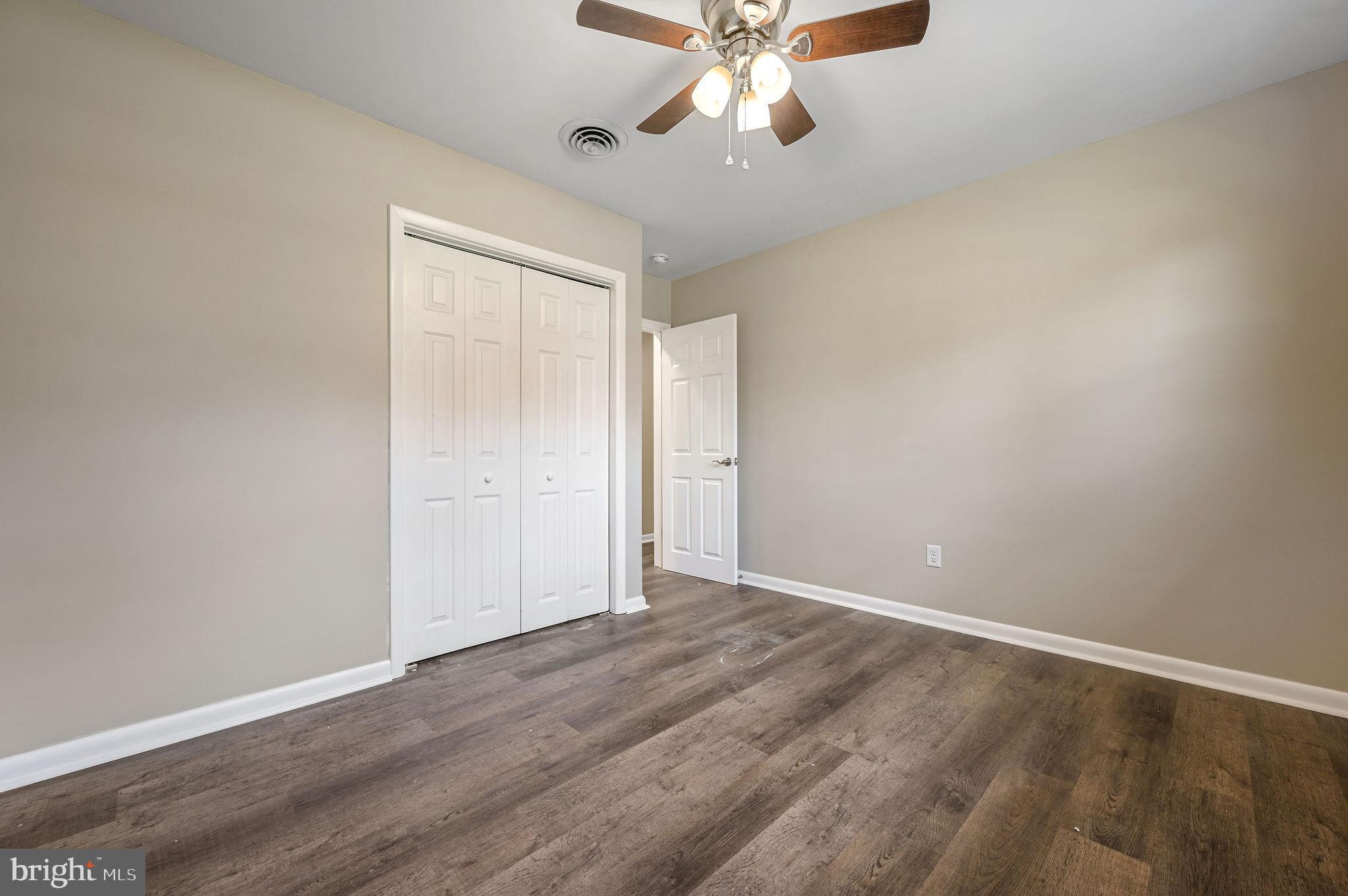 201 North Old Mill Road Dover, DE 19901 - Photo 19 of 27 an empty room with wooden floor fan and windows