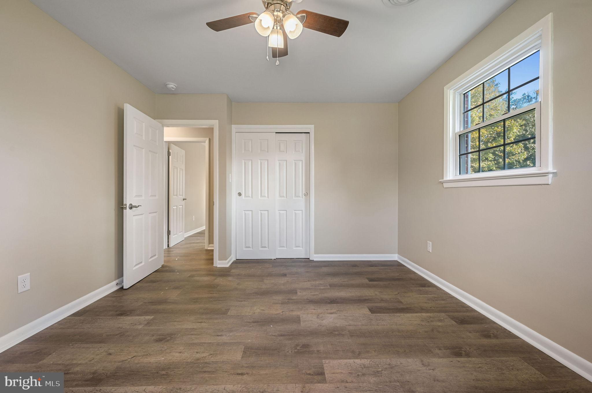 201 North Old Mill Road Dover, DE 19901 - Photo 22 of 27 an empty room with chandelier fan and windows
