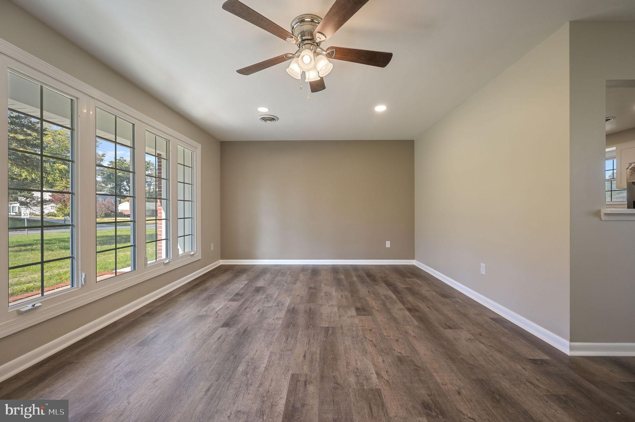 201 North Old Mill Road Dover, DE 19901 - Photo 4 of 27 an empty room with wooden floor and windows