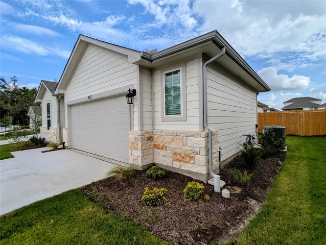 a garden with lots of trees and houses in the background