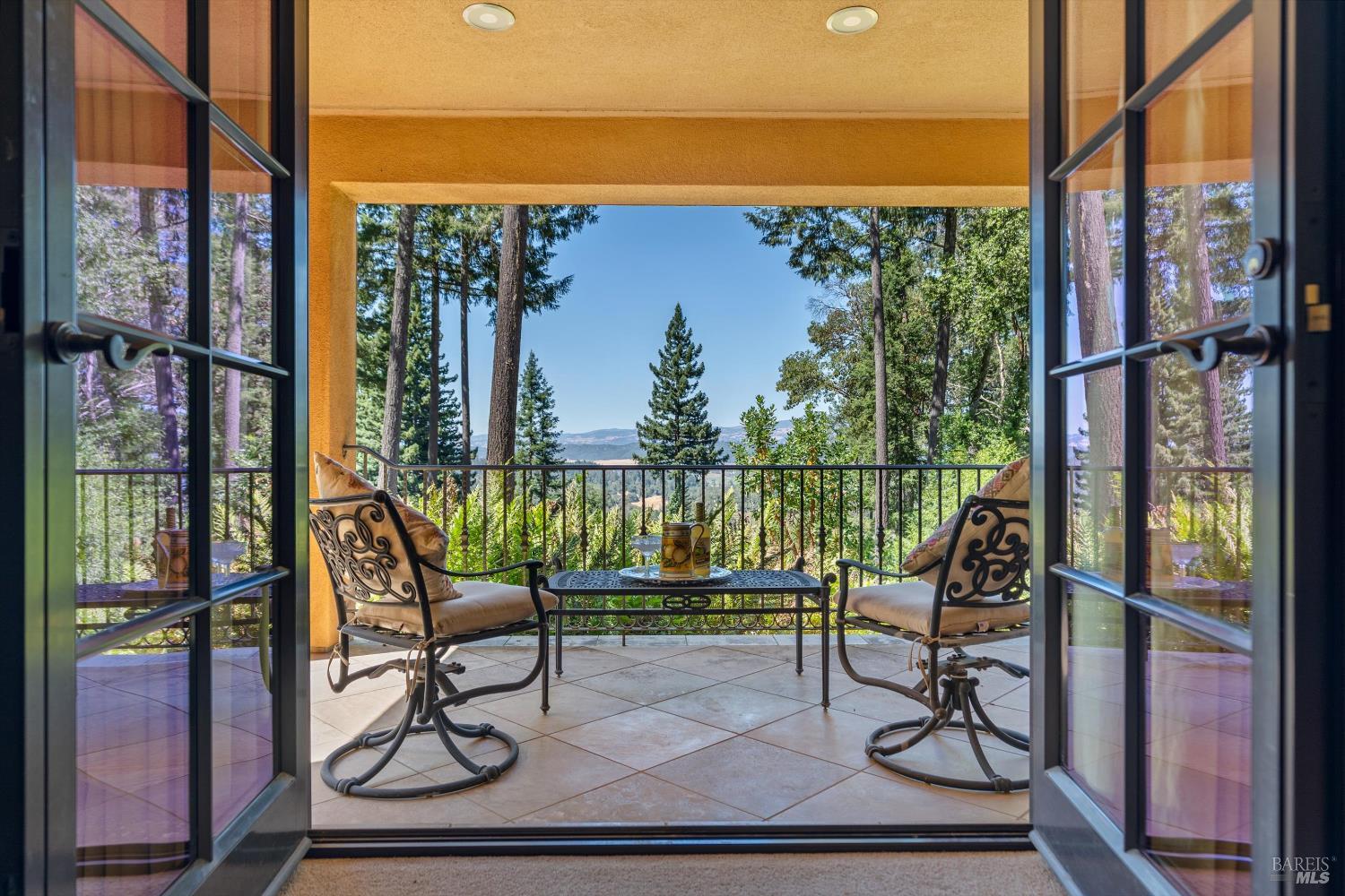 1315 West Dry Creek Road Healdsburg, CA 95448 - Photo 18 of 57 a view of a balcony with chairs and wooden floor