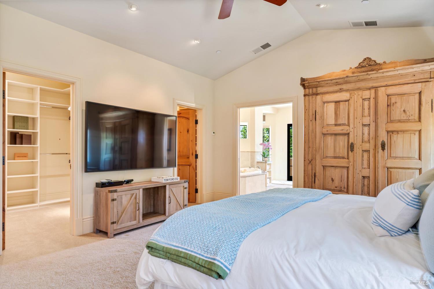 1315 West Dry Creek Road Healdsburg, CA 95448 - Photo 23 of 57 a bedroom with a bed and a flat screen tv