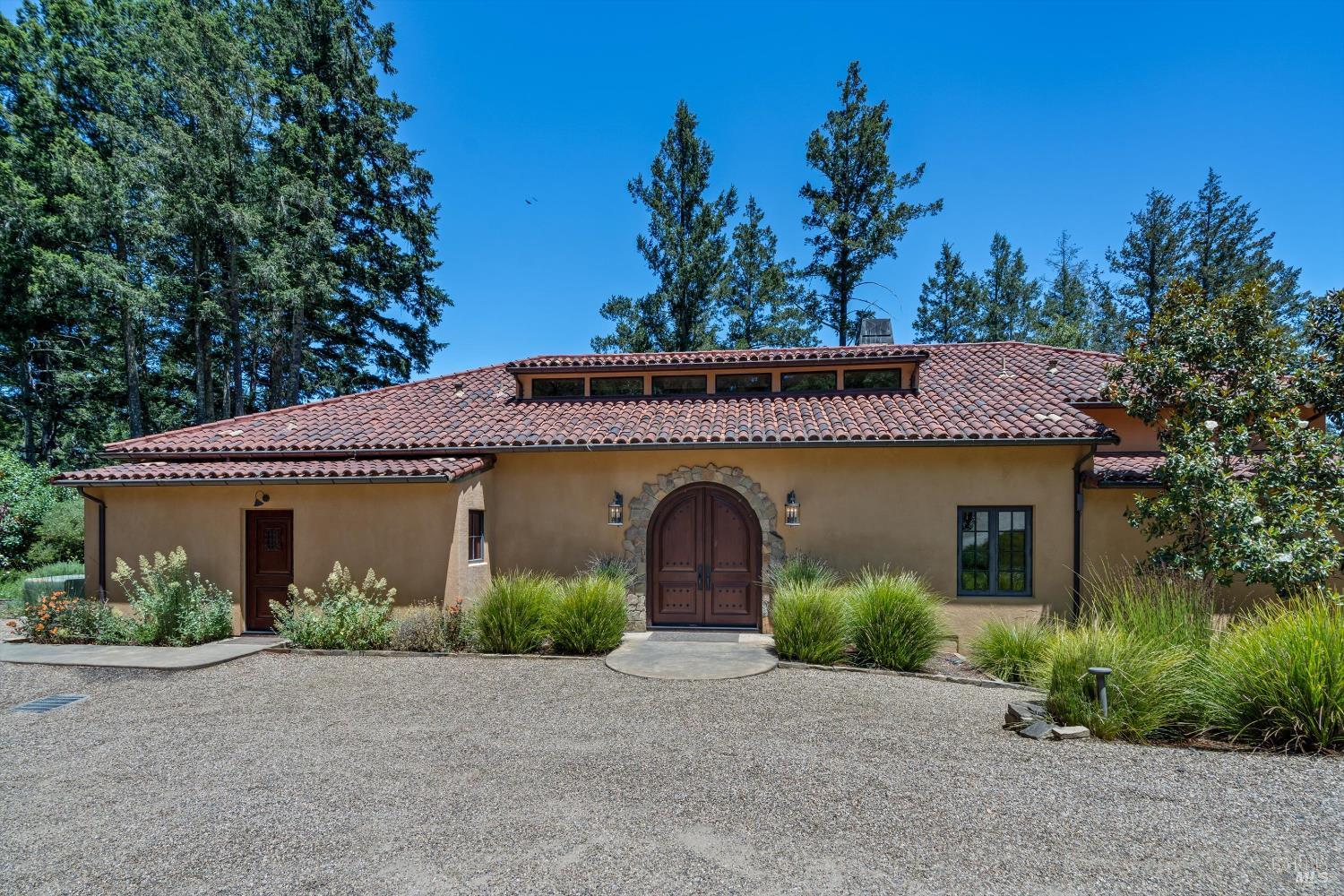 1315 West Dry Creek Road Healdsburg, CA 95448 - Photo 53 of 57 a front view of a house with plants and a garage